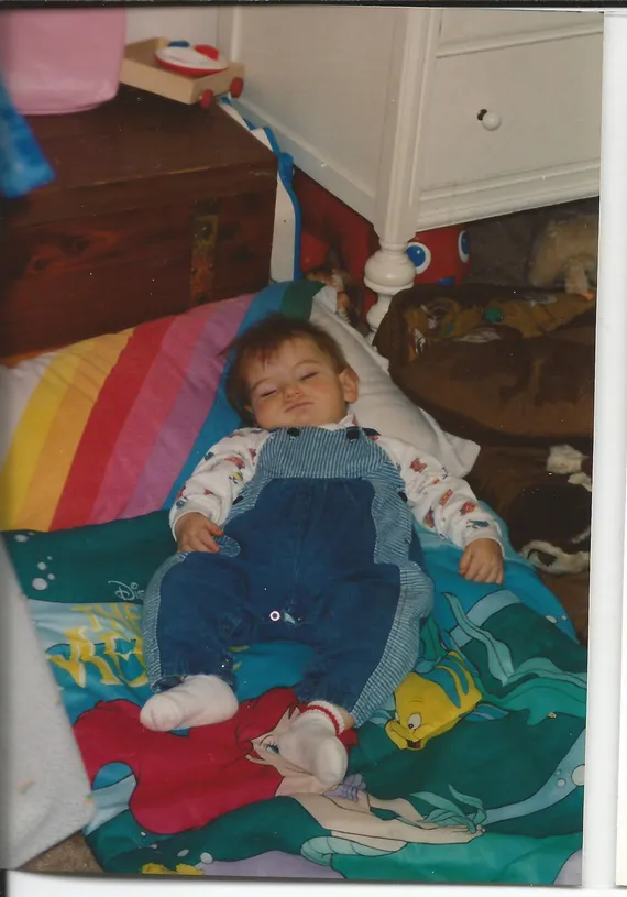 Alex sleeping on the ground as a baby