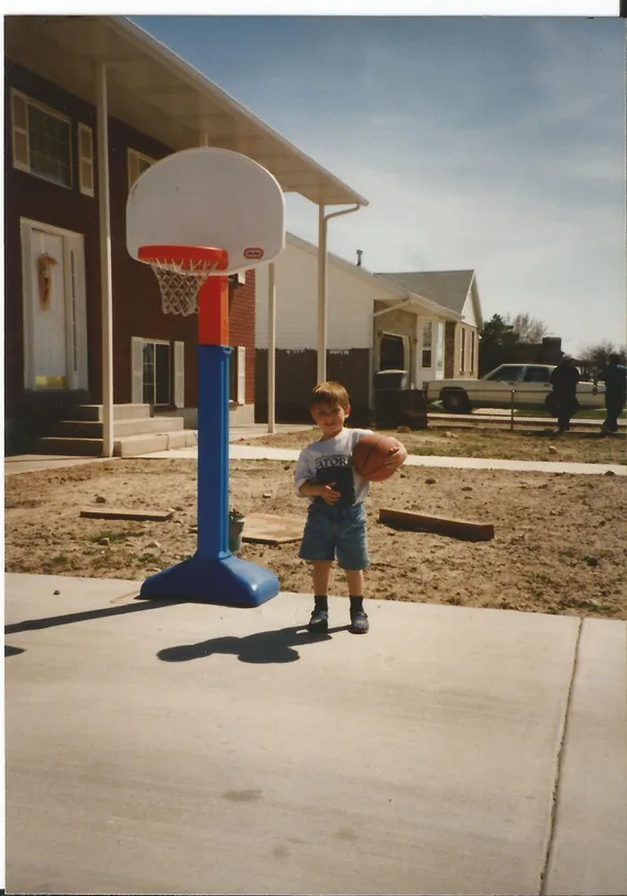 Alex playing basketball in the driveway