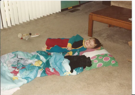 Alex laying down with puppies