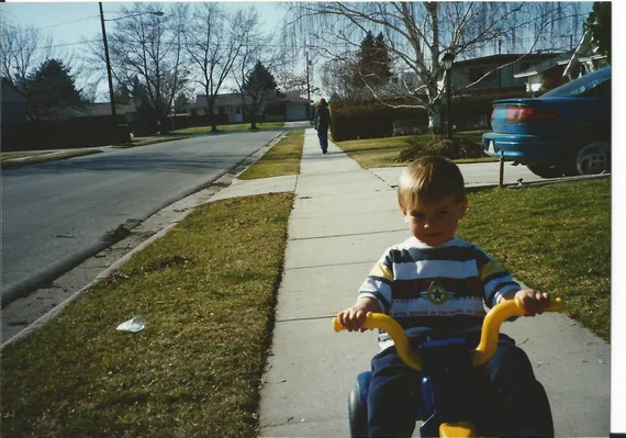 Alex riding a tricycle