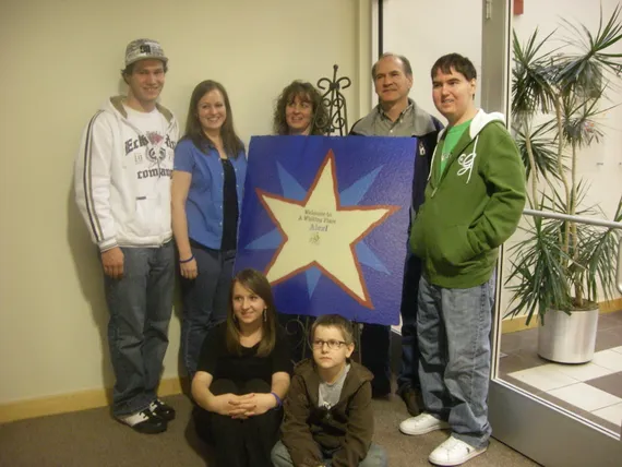 Family photo at Make A Wish Welcome sign