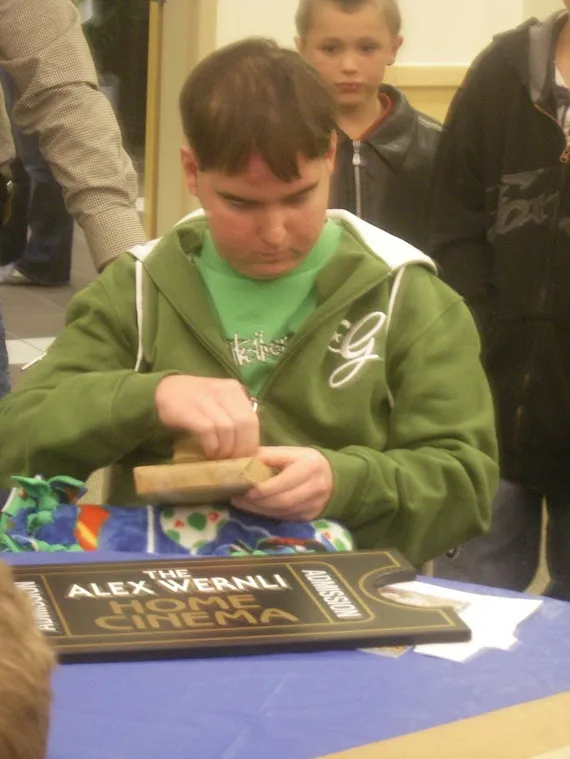 Alex opening a gift from Make A Wish