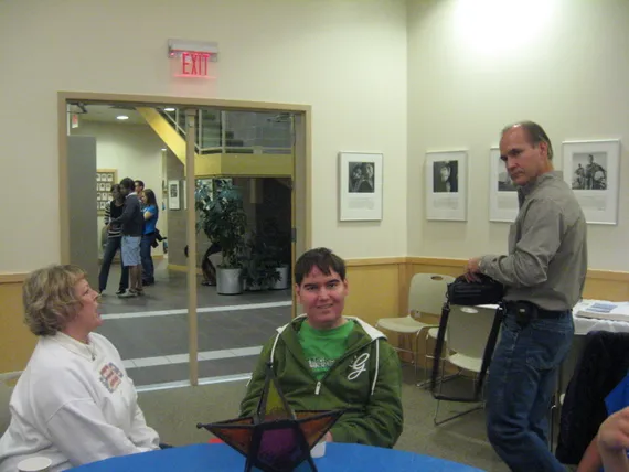 Alex sitting at the table with aunt Kristie
