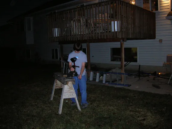 Alex doing science project with a paintball gun