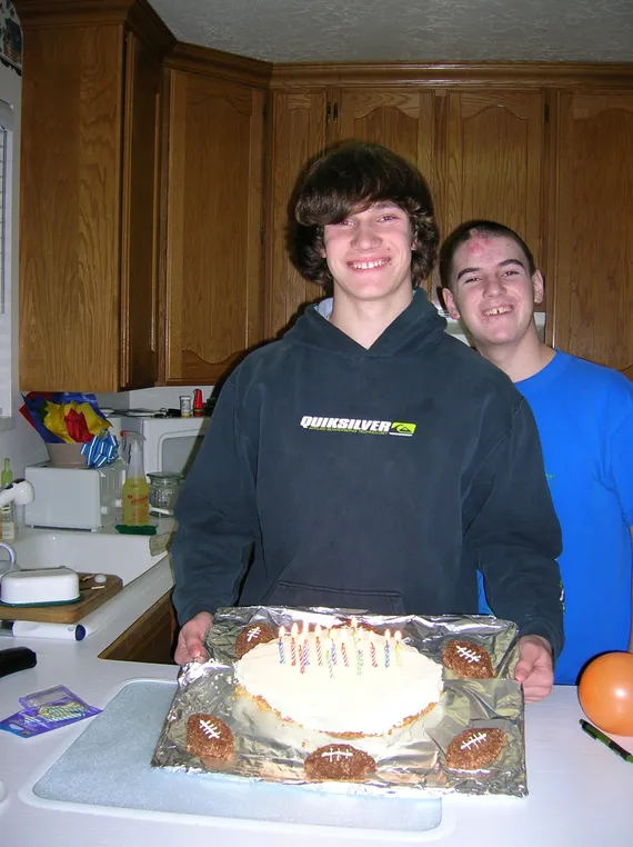 Alex and Chris holding a birthday cake