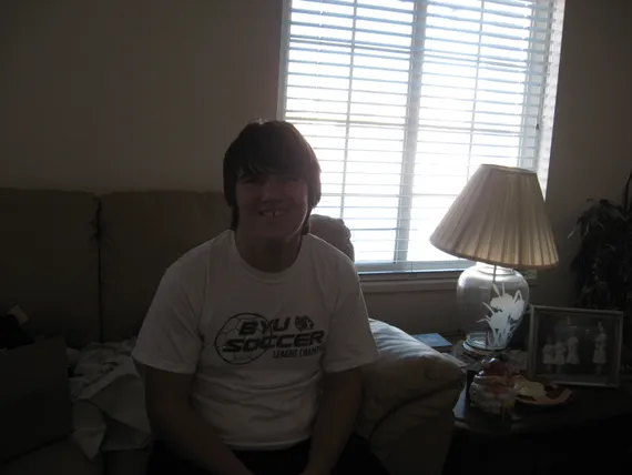 Alex smiling on the couch