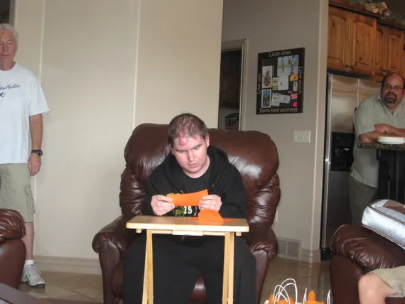 Alex reading his card