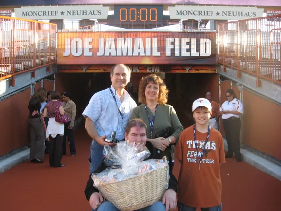 Alex, mom, dad, and Josh at the entrance of the field