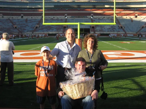 Alex, mom, dad, and Josh on the football field