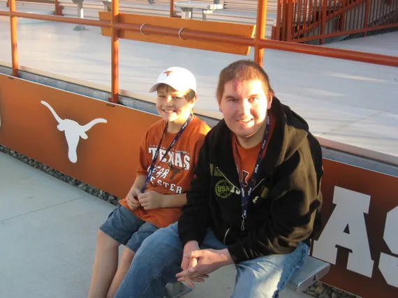 Alex and Josh sitting by the field