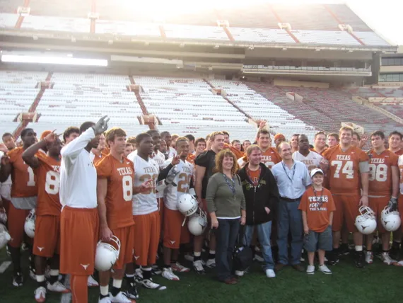 Alex, mom, dad, and Josh with the Texas footbal team