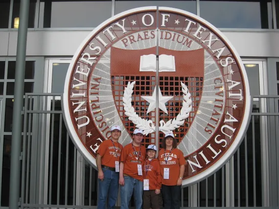 Alex, Mom, Dad, and Josh at UT entrance