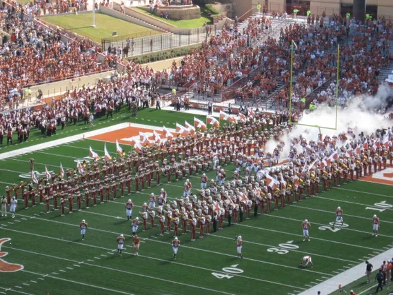 Texas football team running onto the field