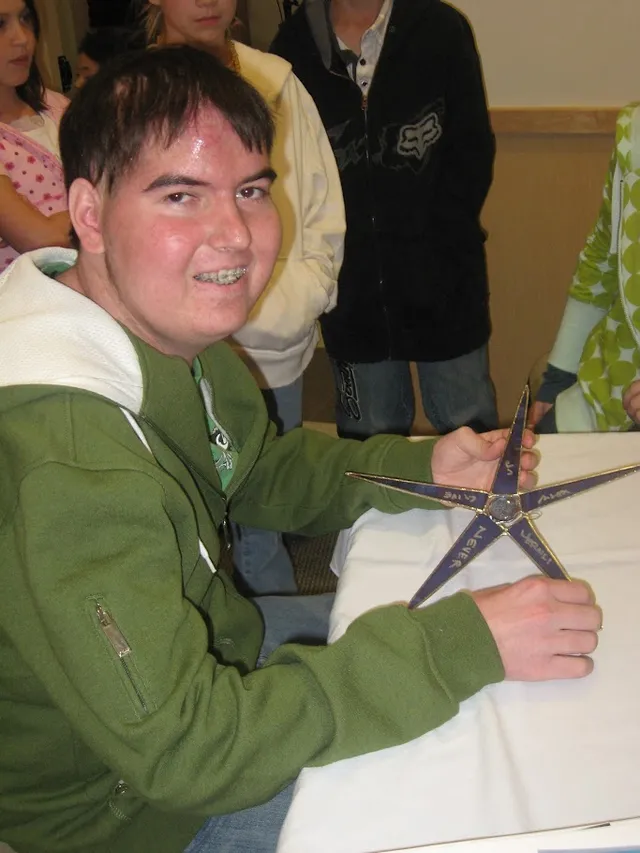 Alex holding his Make A Wish star